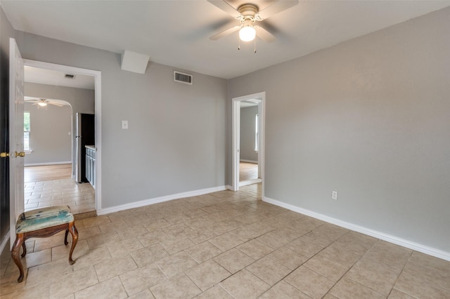 2524 Malvern Trl, Fort Worth, TX 76105 - spare room with a ceiling fan, light tile patterned floors, and baseboards