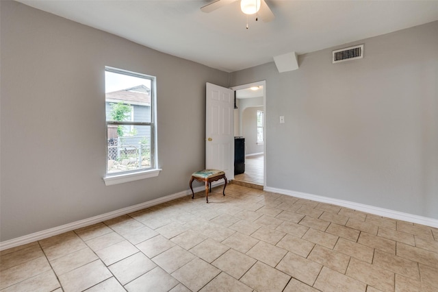 2524 Malvern Trl, Fort Worth, TX 76105 - unfurnished room with plenty of natural light, ceiling fan, baseboards, and light tile patterned floors