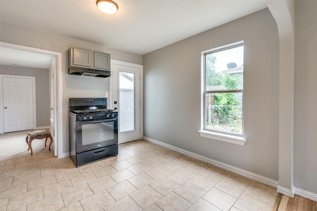 2524 Malvern Trl, Fort Worth, TX 76105 - kitchen featuring black range with gas stovetop, baseboards, under cabinet range hood, gray cabinetry, and arched walkways