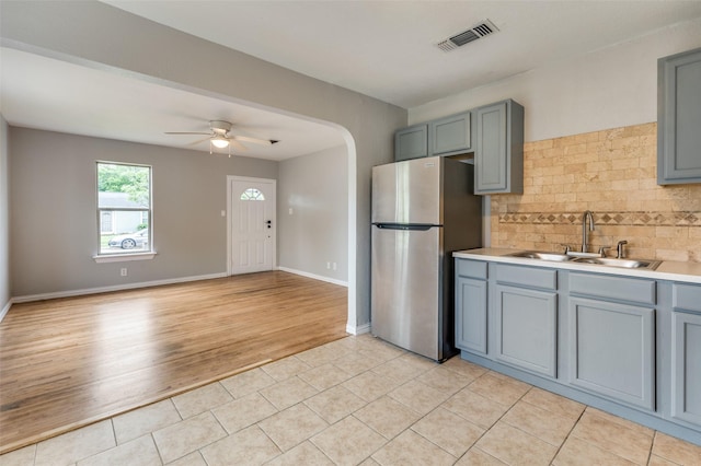 2524 Malvern Trl, Fort Worth, TX 76105 - kitchen with freestanding refrigerator, a sink, gray cabinetry, and backsplash
