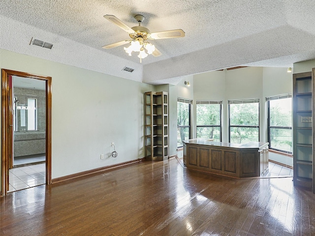 302 Fairway Ct, Willow Park, TX 76087 - unfurnished living room featuring a textured ceiling, healthy amount of natural light, wood-type flooring, ceiling fan, and baseboards