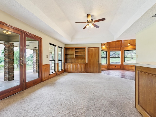 302 Fairway Ct, Willow Park, TX 76087 - unfurnished living room featuring plenty of natural light, light colored carpet, ceiling fan, a raised ceiling, and a textured ceiling