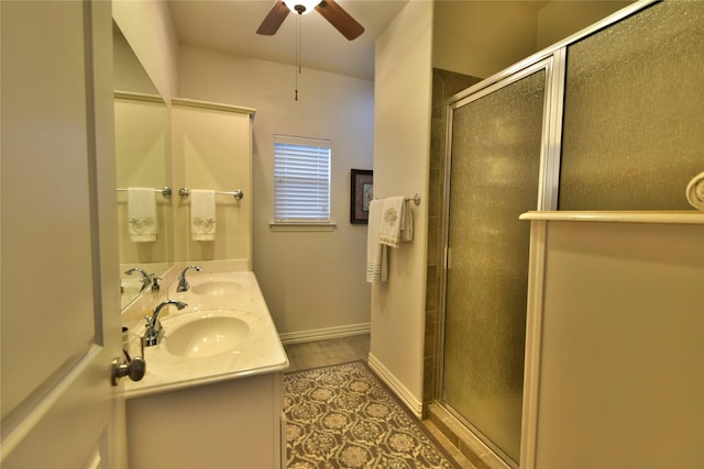 bathroom featuring a stall shower, a ceiling fan, and double vanity