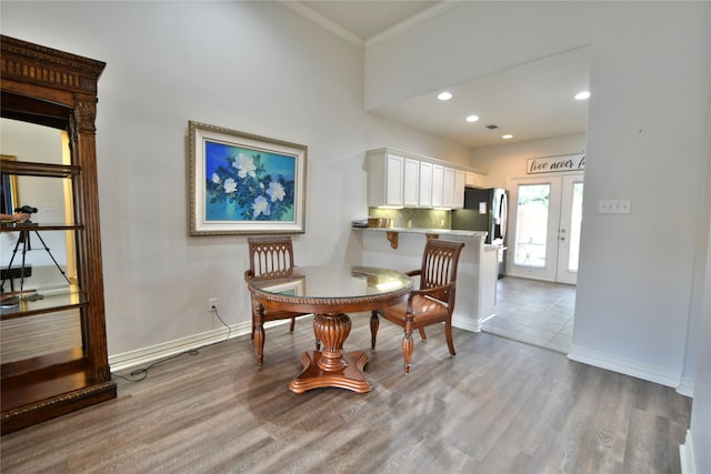 dining room featuring french doors, baseboards, wood finished floors, ornamental molding, and recessed lighting