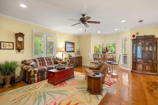 living area featuring light wood-style floors, ceiling fan, recessed lighting, and crown molding