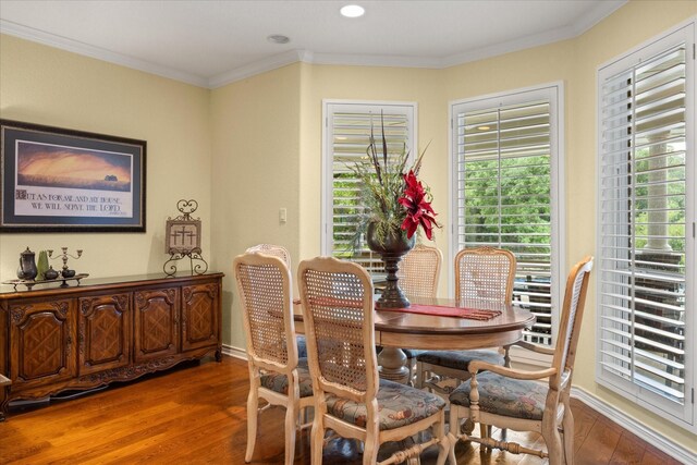 dining room featuring wood finished floors, healthy amount of natural light, baseboards, crown molding, and recessed lighting