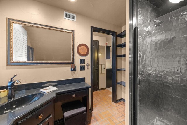 bathroom with brick flooring and vanity