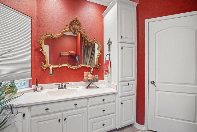bathroom with vanity and a textured wall