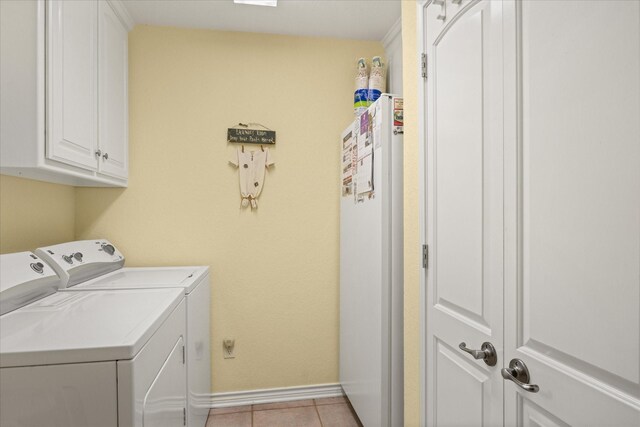 laundry room with washer and dryer, cabinet space, baseboards, and light tile patterned floors