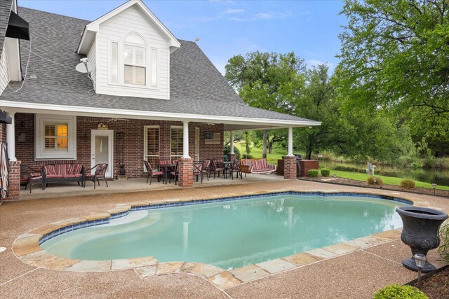 outdoor pool featuring a patio and an outdoor hangout area