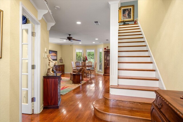staircase with hardwood / wood-style floors, a ceiling fan, recessed lighting, crown molding, and baseboards