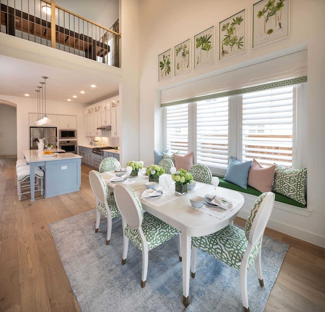 2210 Desmond Dr, Forney, TX 75126 - dining space with arched walkways, light wood-style flooring, baseboards, and recessed lighting