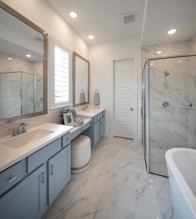 2210 Desmond Dr, Forney, TX 75126 - full bathroom with a marble finish shower, a freestanding tub, marble finish floors, two vanities, and recessed lighting