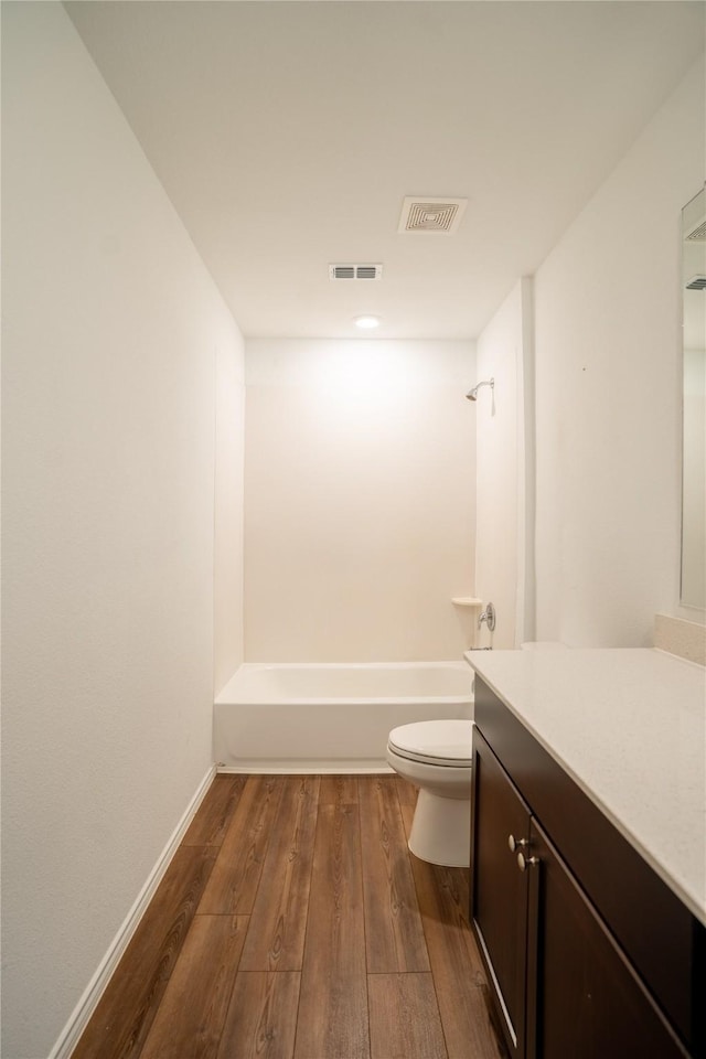 2923 Cascade Ln, Forney, TX 75126 - full bath featuring wood finished floors, toilet, vanity, tub / shower combination, and baseboards