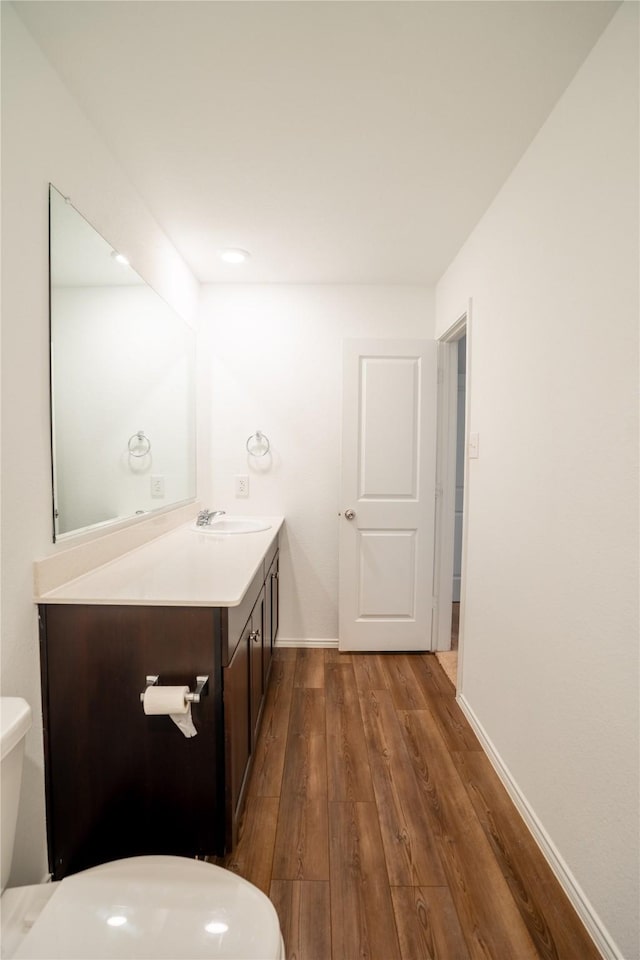 2923 Cascade Ln, Forney, TX 75126 - half bath featuring toilet, wood finished floors, vanity, and baseboards