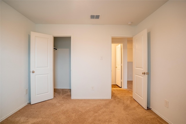 2923 Cascade Ln, Forney, TX 75126 - unfurnished bedroom with light colored carpet, a walk in closet, and baseboards