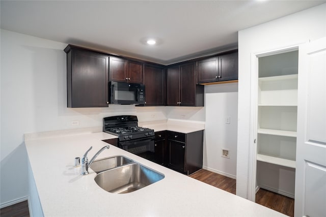 2923 Cascade Ln, Forney, TX 75126 - kitchen featuring black appliances, a sink, dark wood-type flooring, dark brown cabinets, and light countertops