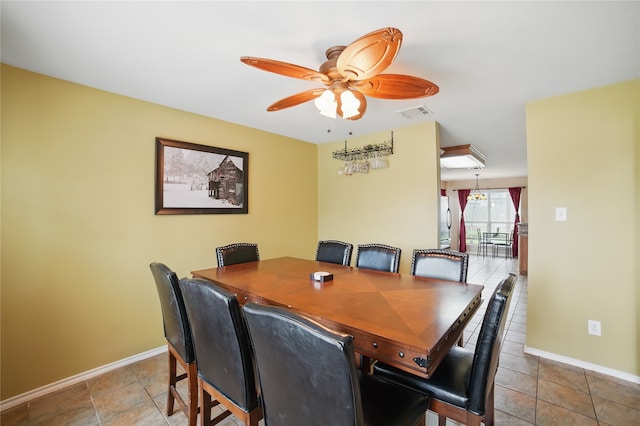 dining area with a ceiling fan and baseboards