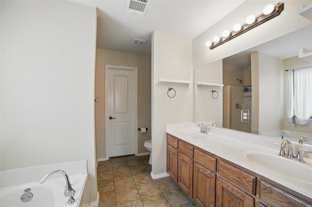 bathroom featuring a garden tub, toilet, a shower, and double vanity