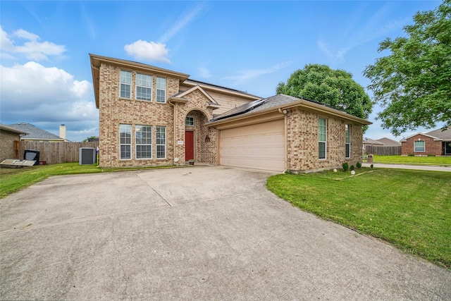 traditional-style home with brick siding, roof mounted solar panels, a garage, and concrete driveway
