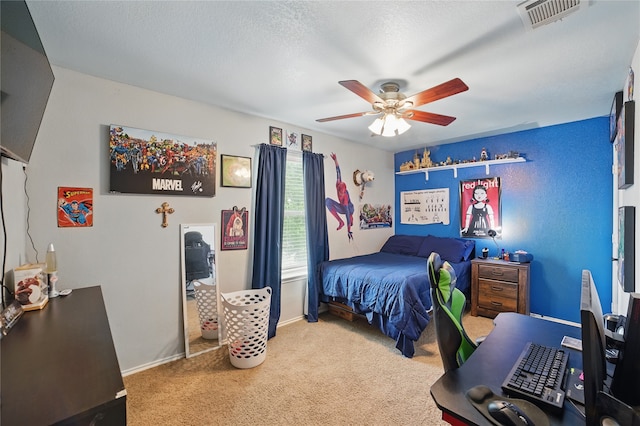 carpeted bedroom with ceiling fan and baseboards