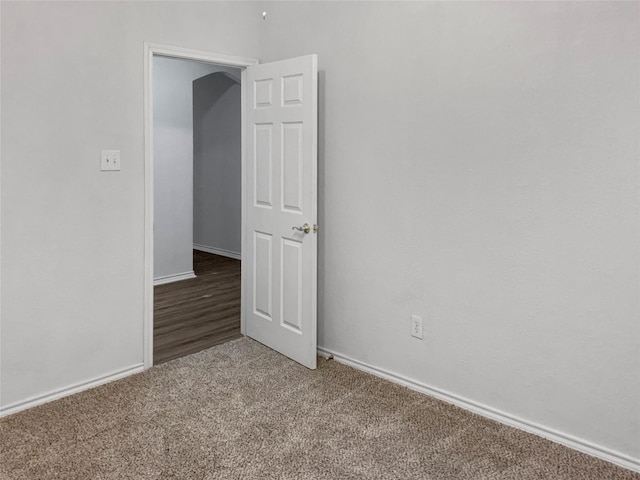carpeted spare room with baseboards