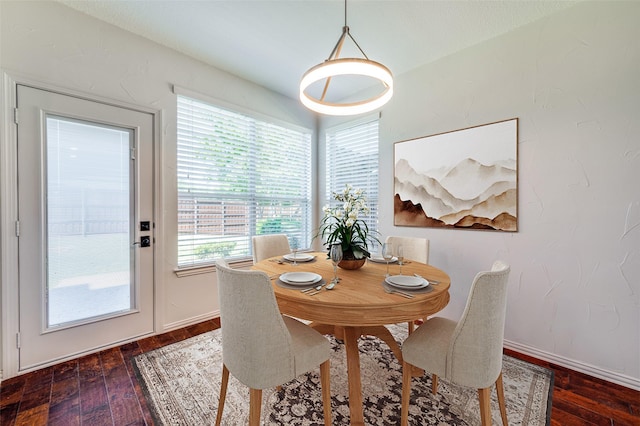 dining room featuring dark wood-style floors and baseboards