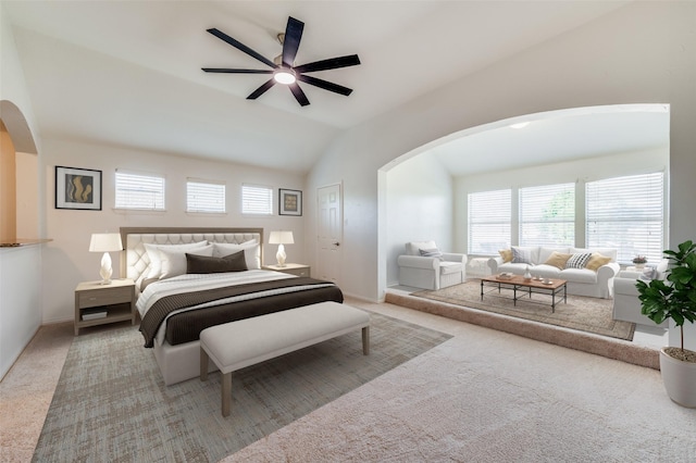 bedroom with arched walkways, carpet, multiple windows, vaulted ceiling, and baseboards