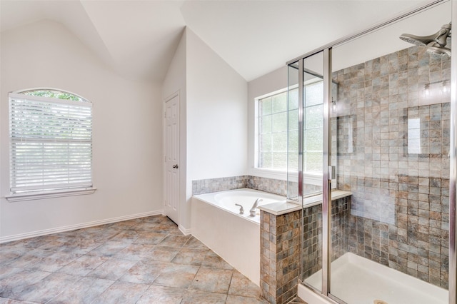 bathroom featuring plenty of natural light, lofted ceiling, a shower stall, and a bath