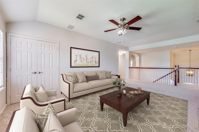 living room with carpet floors, ceiling fan, lofted ceiling, and arched walkways