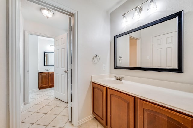 bathroom featuring tile patterned flooring, vanity, and baseboards