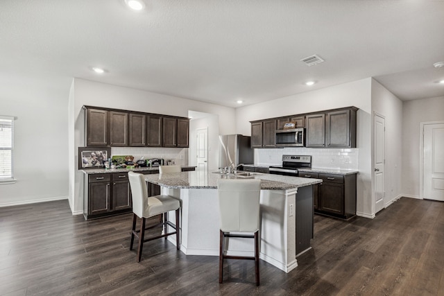 3936 Burks Ct, Celina, TX 75009 - kitchen featuring black appliances, a sink, dark stone countertops, and light tile patterned floors