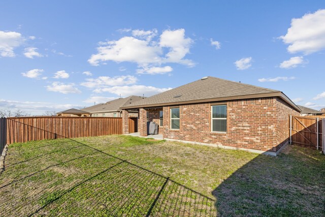 3936 Burks Ct, Celina, TX 75009 - rear view of house with brick siding, a shingled roof, and a patio