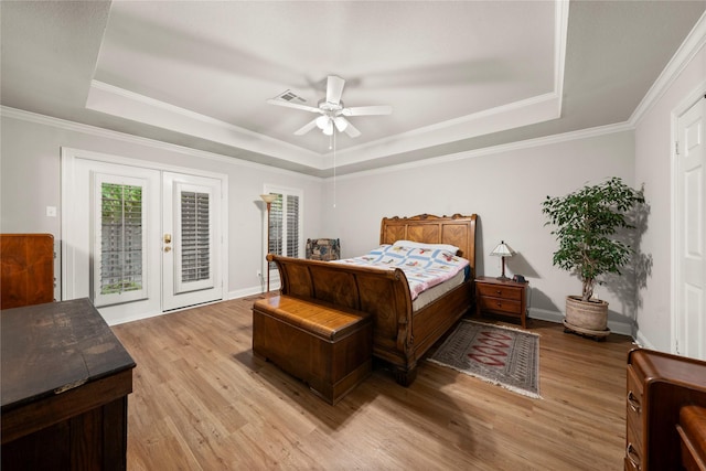 209 Village Cir, Waco, TX 76710 - bedroom featuring a tray ceiling, access to exterior, light wood-style floors, french doors, and crown molding