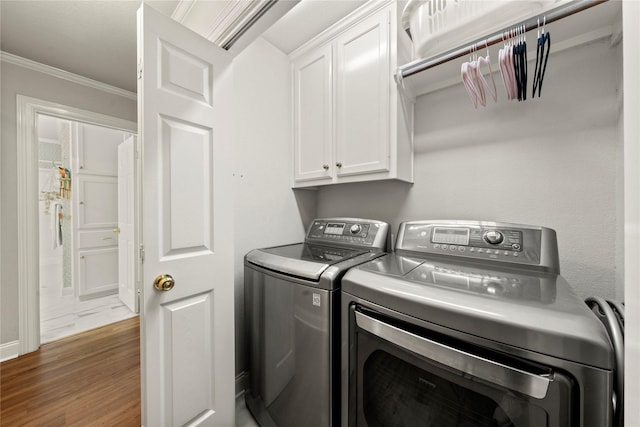 209 Village Cir, Waco, TX 76710 - clothes washing area with cabinet space, separate washer and dryer, ornamental molding, wood finished floors, and baseboards