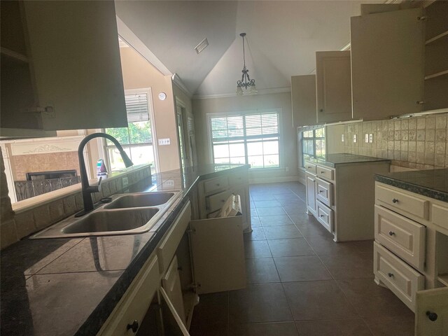 2127 Forest Hills Blvd, Haughton, LA 71037 - kitchen with a sink, backsplash, vaulted ceiling, dark tile patterned floors, and dark countertops