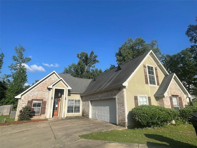 2127 Forest Hills Blvd, Haughton, LA 71037 - view of front of property with brick siding, concrete driveway, a garage, a shingled roof, and stucco siding