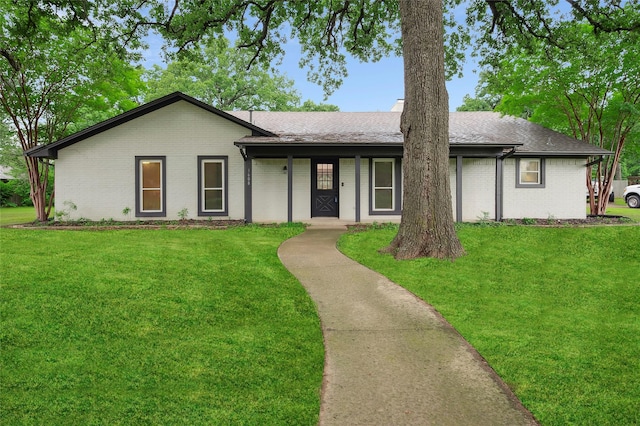 single story home with brick siding, a front lawn, and covered porch