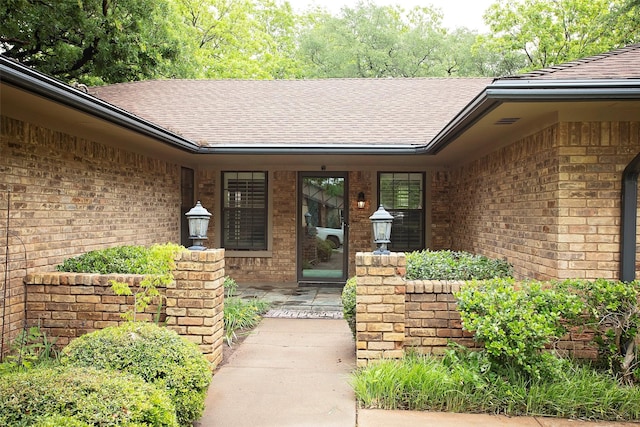 1305 Cliff Dr, Graham, TX 76450 - view of exterior entry with roof with shingles and brick siding
