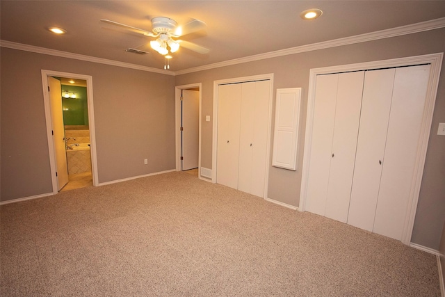 1305 Cliff Dr, Graham, TX 76450 - unfurnished bedroom featuring multiple closets, carpet, ornamental molding, ensuite bath, and recessed lighting