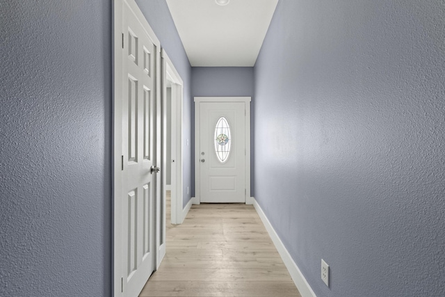 620 S First St, Sherman, TX 75090 - doorway with light wood-style floors, baseboards, and a textured wall
