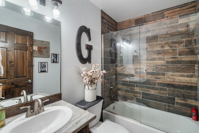 full bathroom featuring enclosed tub / shower combo, toilet, and vanity