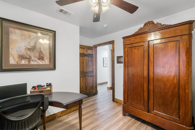 office with a ceiling fan, baseboards, and light wood-type flooring