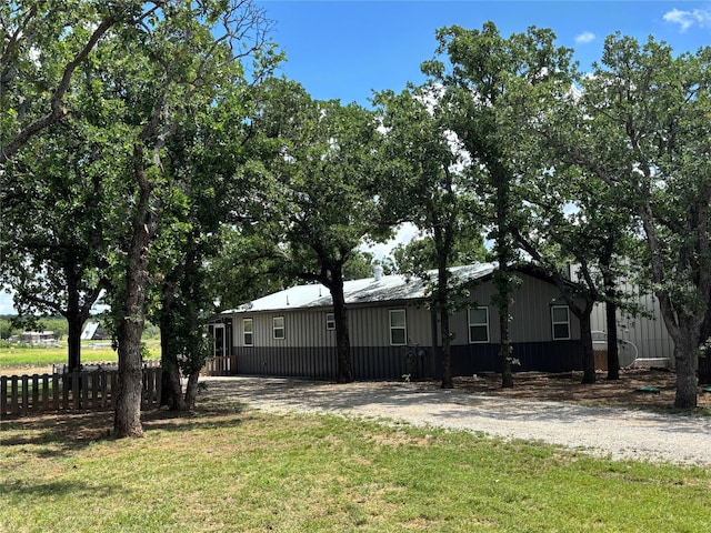 view of side of property featuring dirt driveway