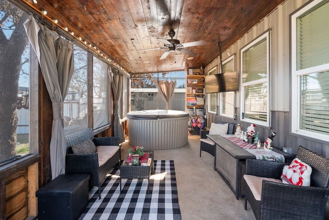 sunroom / solarium with a jacuzzi, outdoor lounge area, and ceiling fan