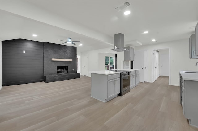 4032 Aragon Dr, Fort Worth, TX 76133 - kitchen with stainless steel electric stove, island exhaust hood, gray cabinets, and recessed lighting