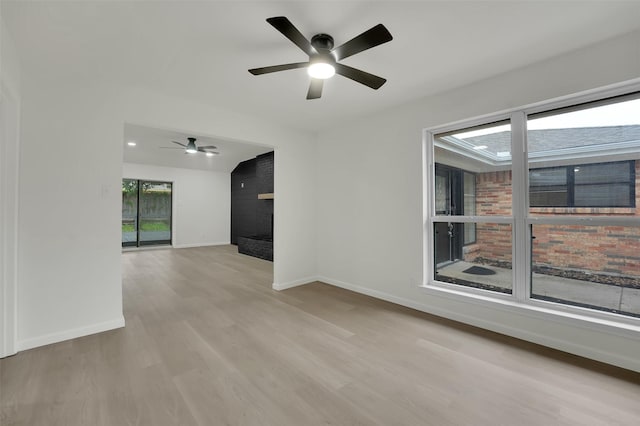 4032 Aragon Dr, Fort Worth, TX 76133 - unfurnished room featuring a ceiling fan, baseboards, a fireplace, and wood finished floors