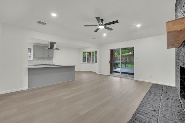 4032 Aragon Dr, Fort Worth, TX 76133 - unfurnished living room with ceiling fan, light wood finished floors, a fireplace, baseboards, and recessed lighting