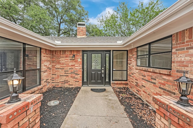 4032 Aragon Dr, Fort Worth, TX 76133 - entrance to property featuring brick siding, a shingled roof, and a chimney
