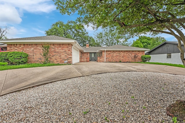 4032 Aragon Dr, Fort Worth, TX 76133 - view of home's exterior with an attached garage, brick siding, a chimney, and concrete driveway